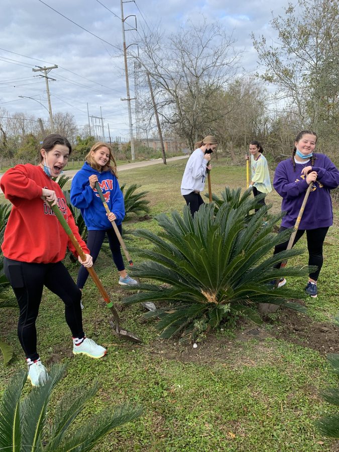 Juniors work hard digging up invasive species that are not native to New Orleans and negatively impact the environment.